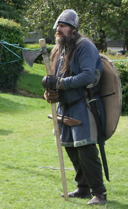 a Viking leans on his long axe